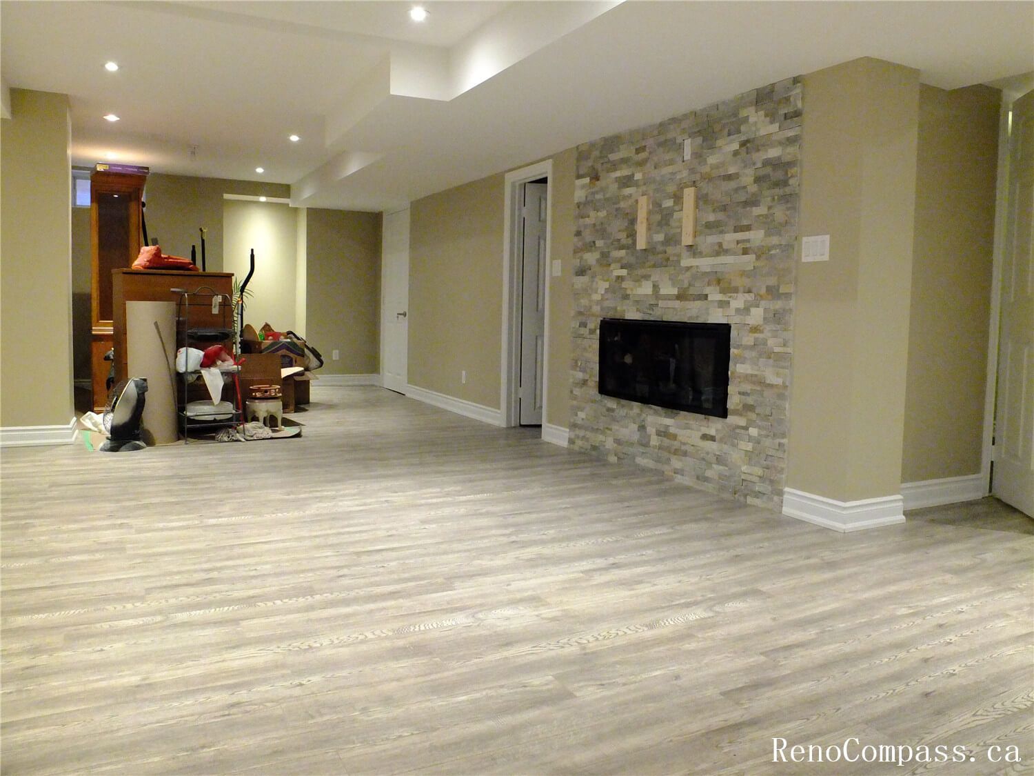 This Ajax basement renovation features a spacious open-concept layout with newly installed modern vinyl flooring, smooth painted walls, and recessed pot lights that brighten the entire space. The neutral color palette and clean finishes create a comfortable and versatile living area suitable for a family room, entertainment space, or home office. Completed by a professional Toronto Renovation Company, this project focuses on durability, efficient lighting design, and practical basement living upgrades for modern homes.