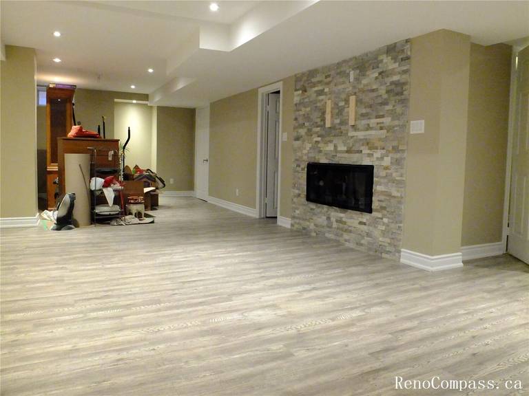 This Ajax basement renovation features a spacious open-concept layout with newly installed modern vinyl flooring, smooth painted walls, and recessed pot lights that brighten the entire space. The neutral color palette and clean finishes create a comfortable and versatile living area suitable for a family room, entertainment space, or home office. Completed by a professional Toronto Renovation Company, this project focuses on durability, efficient lighting design, and practical basement living upgrades for modern homes.