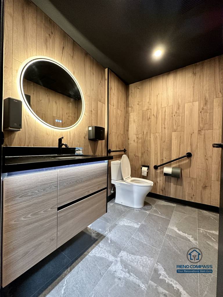 This Mississauga restaurant renovation includes a modern commercial washroom with durable finishes, custom vanity cabinetry, and integrated lighting. The design focuses on easy maintenance, long-term durability, and a clean, professional appearance suitable for high-traffic restaurant use.