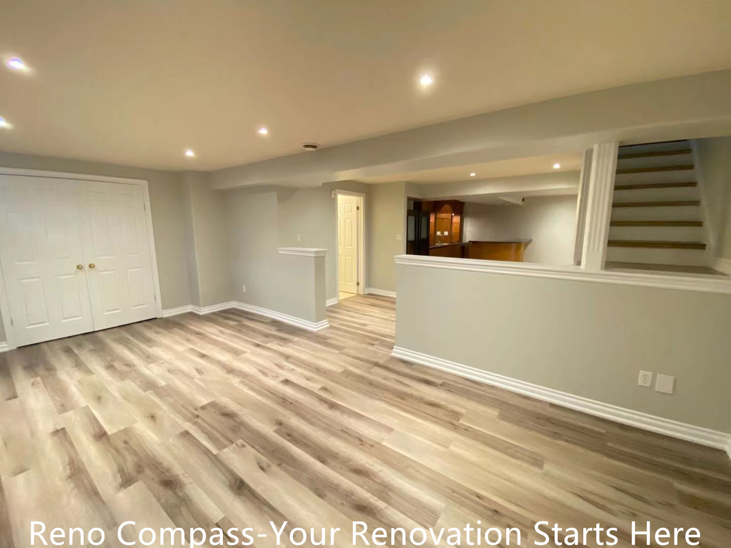 This Oakville interior renovation features a newly finished open-concept basement designed to maximize space, brightness, and everyday usability. Wide-plank vinyl flooring provides durability and a natural wood appearance, while recessed ceiling lights create even illumination throughout the area. Half-height partition walls subtly define zones without blocking sightlines, maintaining an open and connected layout. Neutral wall tones enhance the sense of openness, making the basement suitable for a family room, recreation space, or home office. This project demonstrates a practical and modern basement transformation completed by an experienced Toronto renovation company.