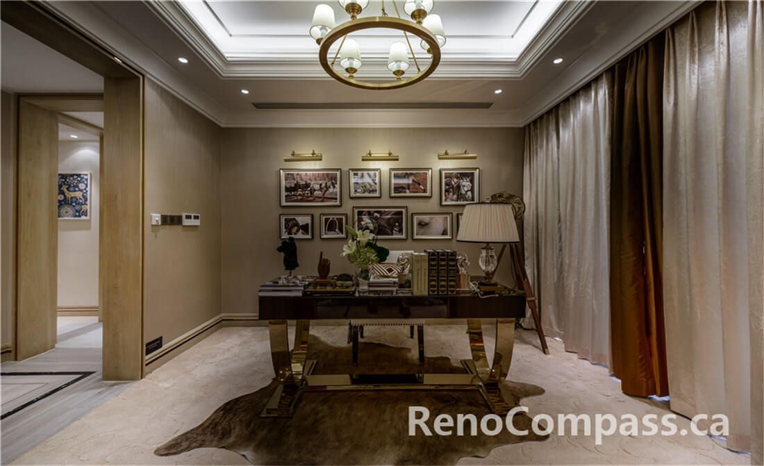 This Toronto interior renovation showcases a refined home office and study space featuring custom wall finishes, recessed ceiling lighting, and a statement chandelier. The warm neutral palette, tailored drapery, and curated art display create a sophisticated yet comfortable workspace. Thoughtful layout planning ensures seamless flow between adjoining rooms while maintaining privacy and functionality. Completed by a professional Toronto Renovation Company, this project highlights premium craftsmanship, elegant detailing, and timeless residential interior design.