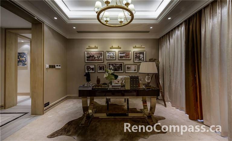 This Toronto interior renovation showcases a refined home office and study space featuring custom wall finishes, recessed ceiling lighting, and a statement chandelier. The warm neutral palette, tailored drapery, and curated art display create a sophisticated yet comfortable workspace. Thoughtful layout planning ensures seamless flow between adjoining rooms while maintaining privacy and functionality. Completed by a professional Toronto Renovation Company, this project highlights premium craftsmanship, elegant detailing, and timeless residential interior design.