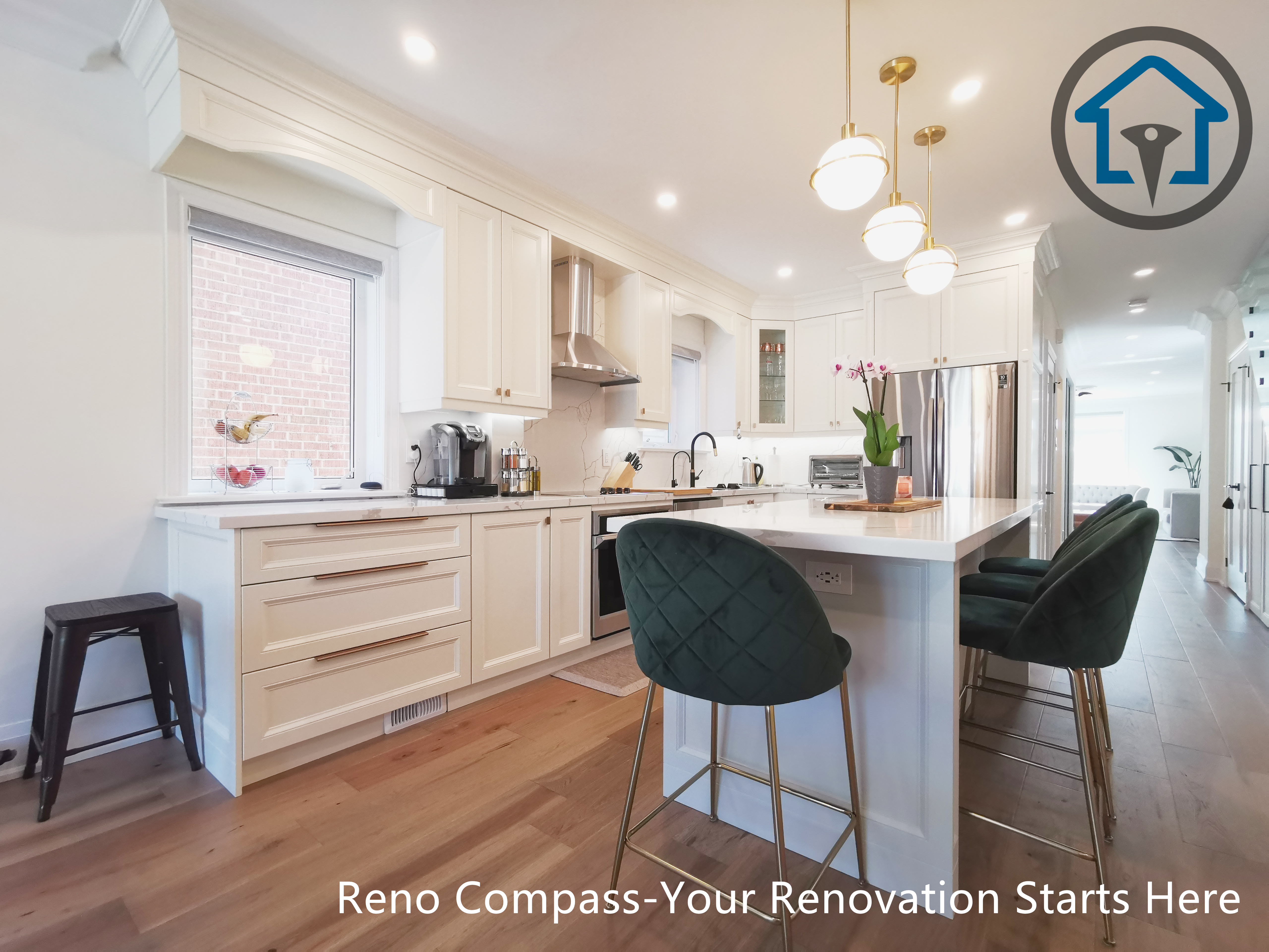 This image features the main kitchen island from a North York interior renovation, highlighting a large quartz countertop paired with elegant pendant lighting. The island provides generous seating and prep space, serving as the functional and visual center of the kitchen. White shaker cabinetry, stainless steel appliances, and a modern range hood create a clean, cohesive look, while the open sightline connects the kitchen seamlessly to the adjacent living area. Warm hardwood flooring balances the bright finishes and enhances overall comfort. Completed by a Toronto renovation company, this kitchen renovation emphasizes usability, material quality, and a refined open-concept layout.