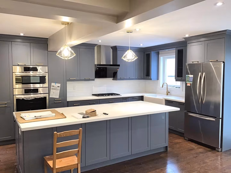 This Richmond Hill interior partial renovation project features a modern open-concept kitchen upgrade with custom grey cabinetry, quartz countertop island, built-in stainless steel appliances, and contemporary pendant lighting. The renovation focuses on improving functionality, storage, and overall visual flow while maintaining a clean and elegant design. Completed by Reno Compass, this interior remodeling project enhances everyday living with high-quality craftsmanship and a modern aesthetic suitable for family homes in Richmond Hill and the Greater Toronto Area.
