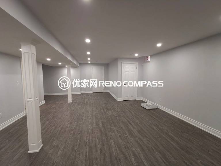 Richmond Hill basement renovation featuring a spacious open-concept layout, modern waterproof flooring, structural support columns, and recessed pot light installation. The newly finished basement offers bright lighting and flexible living space, completed by a professional Toronto renovation company.