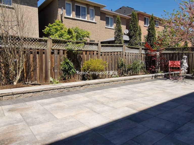 This Mississauga backyard renovation showcases a professionally installed interlocking stone patio with clean modern lines and a raised garden retaining wall. Large-format pavers create a durable and elegant outdoor flooring solution, while the stone border and planting area add depth and structure to the landscape. Completed by an experienced Toronto renovation and landscaping team, this project enhances outdoor usability, drainage, and long-term property value with low-maintenance, high-quality materials.