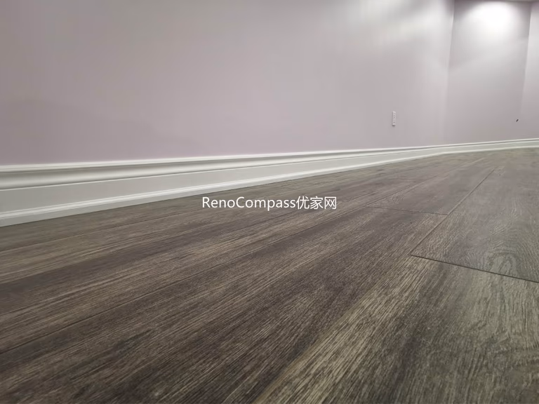 Close-up view of newly installed wood-look flooring in this Richmond Hill basement renovation project. The durable, moisture-resistant flooring was carefully installed with clean baseboard finishing to ensure long-term performance and modern aesthetics. Completed by a trusted Toronto renovation company, this upgraded basement flooring enhances comfort, visual warmth, and overall home value while providing a low-maintenance solution for everyday living.
