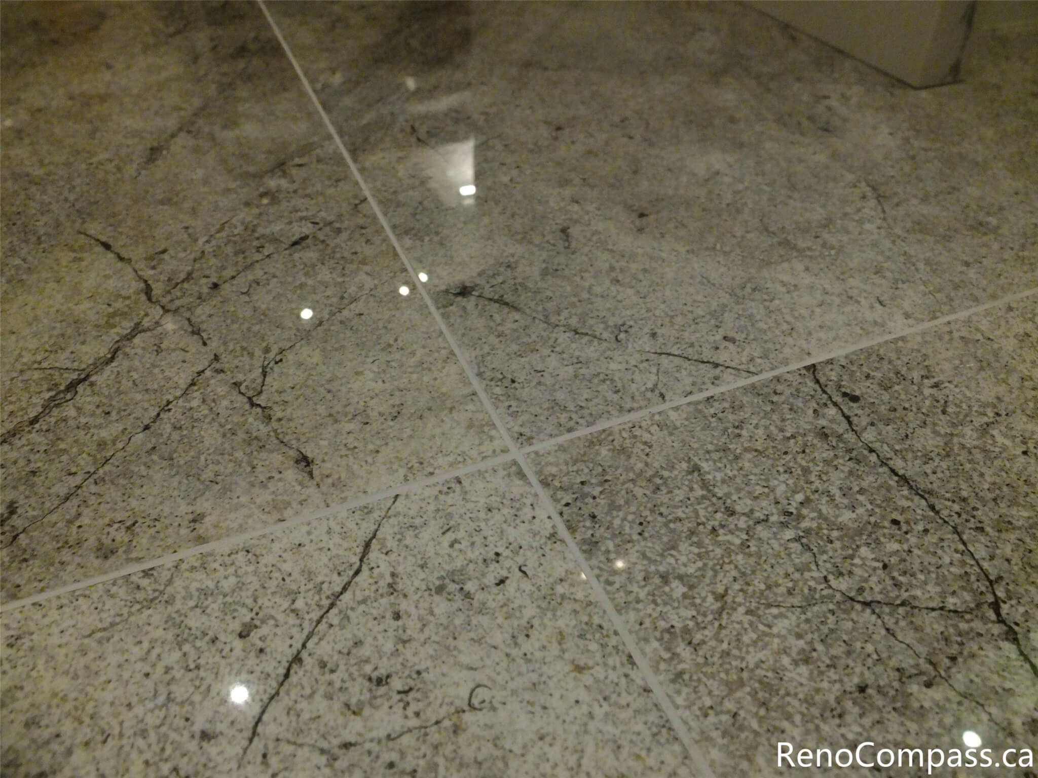 This image highlights the polished tile flooring used in a North York kitchen renovation, featuring a clean grout layout, subtle stone veining, and a reflective finish that enhances brightness and durability. The flooring selection complements the modern kitchen design and was professionally installed as part of a complete renovation by a trusted Toronto renovation company.