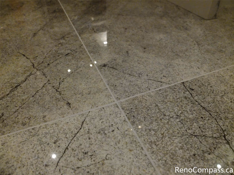 This image highlights the polished tile flooring used in a North York kitchen renovation, featuring a clean grout layout, subtle stone veining, and a reflective finish that enhances brightness and durability. The flooring selection complements the modern kitchen design and was professionally installed as part of a complete renovation by a trusted Toronto renovation company.