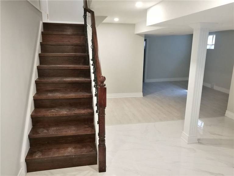 Scarborough whole-house interior renovation featuring upgraded basement staircase, new flooring installation, and modern lighting improvements. This project enhances safety, functionality, and overall interior appearance, creating a clean and durable finished basement space by a professional Toronto renovation contractor.