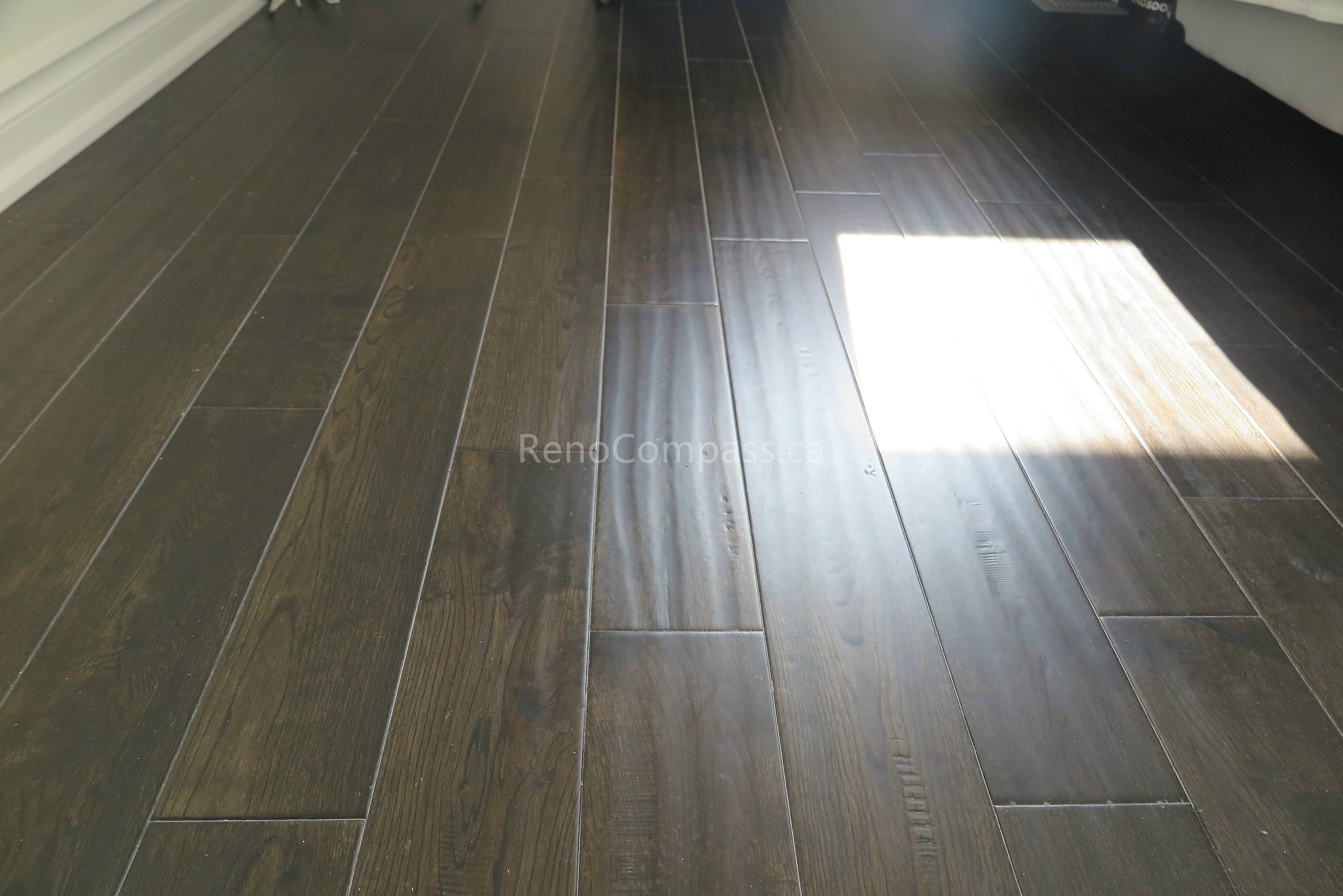 This North York flooring project highlights premium dark hardwood floor installation with a smooth finish and natural wood grain texture. The carefully aligned planks create a seamless and modern look that enhances both durability and visual appeal. Completed by Reno Compass Inc., this flooring upgrade adds warmth, elegance, and long-lasting performance to the home’s interior living space.