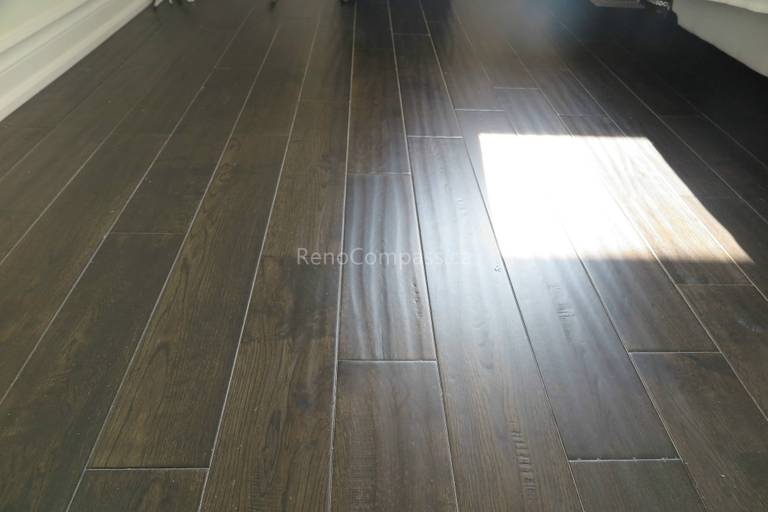 This North York flooring project highlights premium dark hardwood floor installation with a smooth finish and natural wood grain texture. The carefully aligned planks create a seamless and modern look that enhances both durability and visual appeal. Completed by Reno Compass Inc., this flooring upgrade adds warmth, elegance, and long-lasting performance to the home’s interior living space.