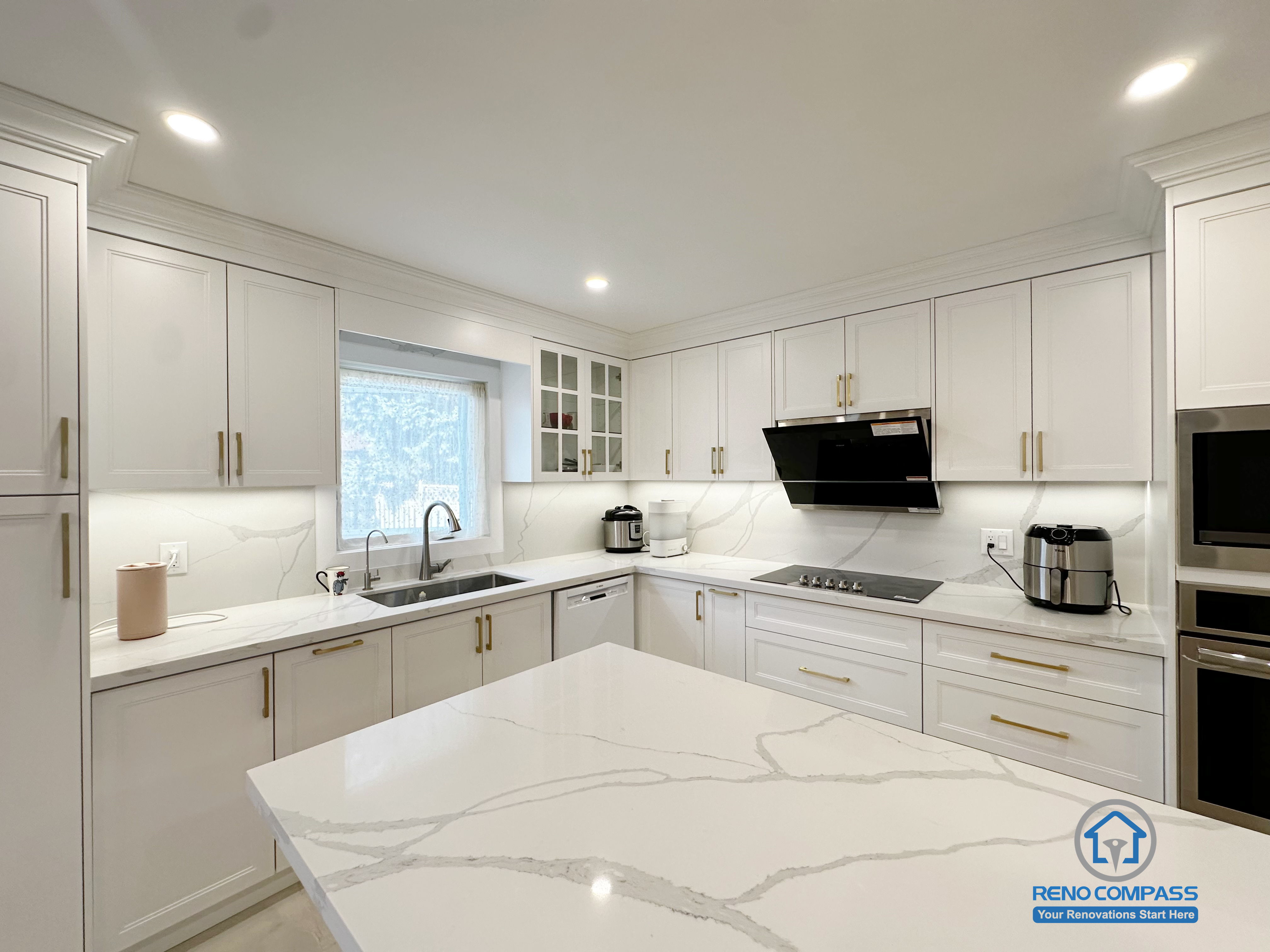 This Richmond Hill interior renovation presents a U-shaped kitchen workspace designed for efficient daily use. Quartz countertops provide generous preparation surfaces, while the integrated sink, cooktop, and cabinetry create a clear and functional working layout. Natural light from the window enhances visibility across the main work zones, supporting both practicality and comfort. Completed as part of a Toronto renovation project focused on workflow optimization, material durability, and clean modern detailing.