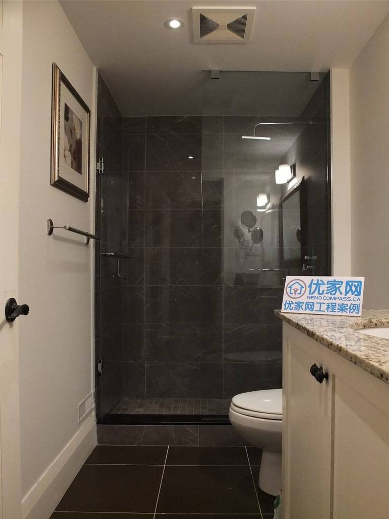 This Oakville basement bathroom renovation features a modern glass shower enclosure with dark tile walls, a granite vanity countertop, and clean white cabinetry. The design combines elegant materials with practical functionality, creating a stylish and comfortable bathroom space. Completed by a professional Toronto Renovation Company, the project highlights precise tile installation, contemporary fixtures, and refined finishing details suitable for modern homes in Oakville and the Greater Toronto Area.