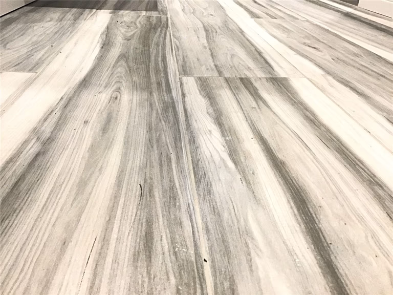 This Richmond Hill basement renovation features durable wood-look vinyl plank flooring with natural grain texture and modern grey tones. The flooring provides a waterproof and low-maintenance solution, making it ideal for basement spaces while maintaining a stylish hardwood appearance. A popular choice for basement finishing projects in Richmond Hill.