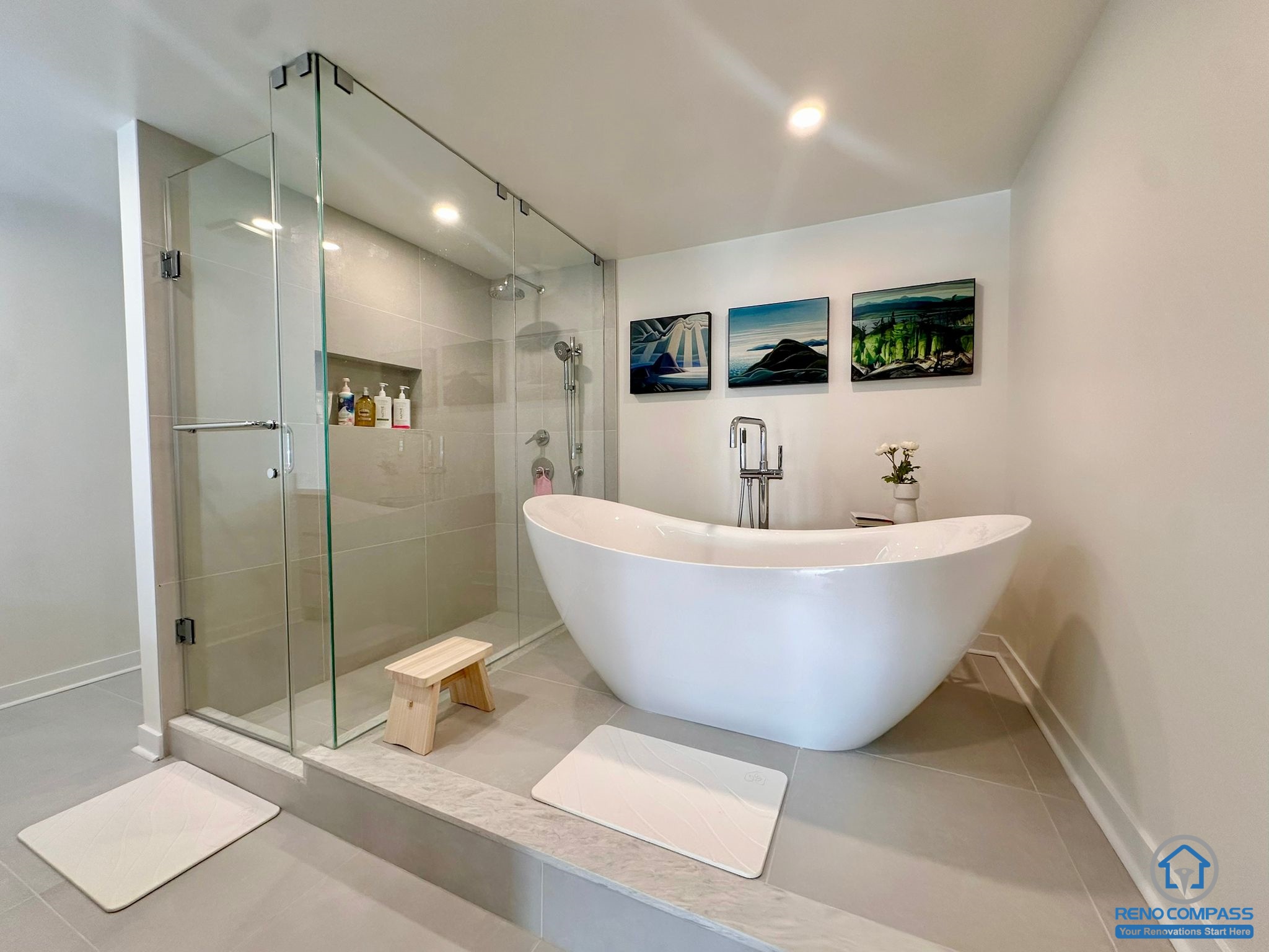 A luxury bathroom renovation in Toronto showcasing a frameless glass shower, freestanding soaking tub, and modern tile finishes. This spa-inspired design offers a clean, elegant, and relaxing atmosphere with improved layout and lighting.
