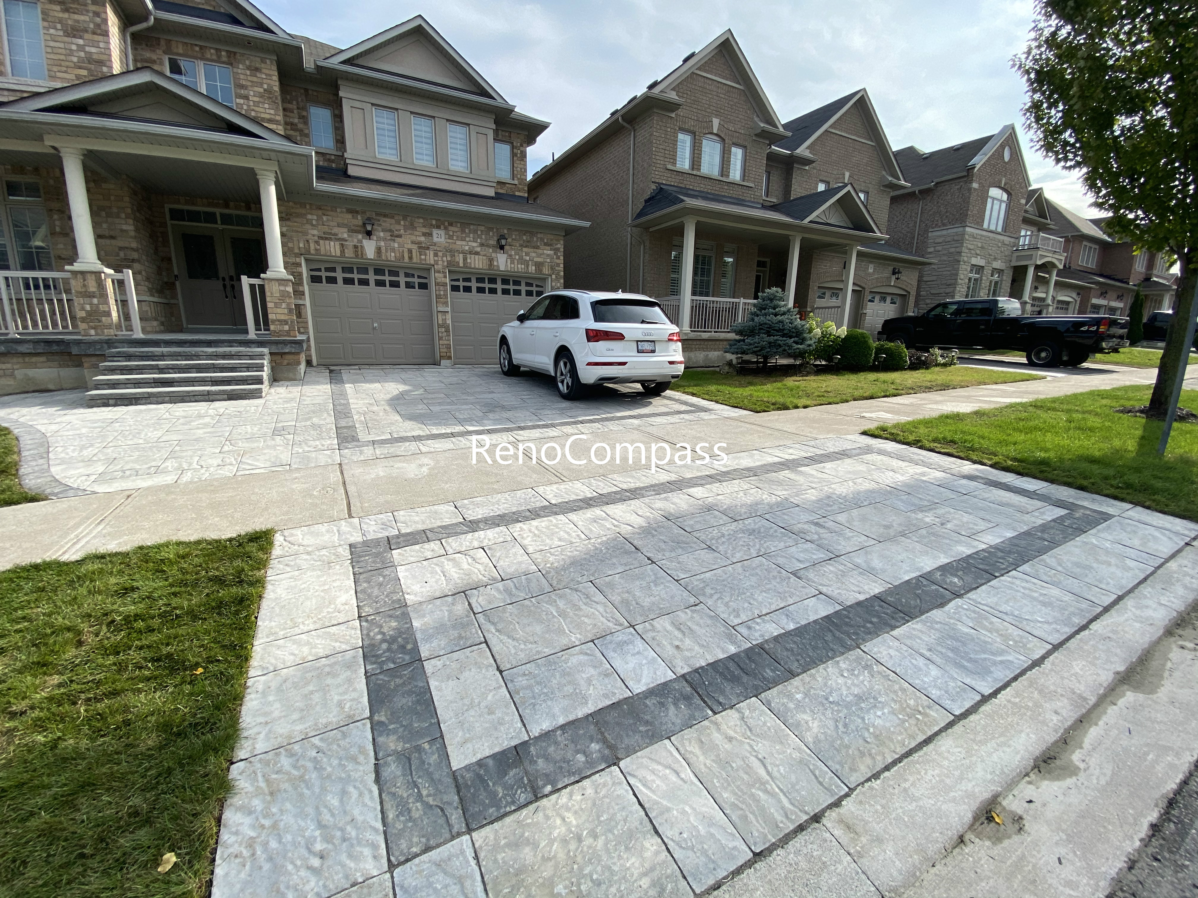 This Aurora front and backyard interlocking project features a modern driveway design using large-format concrete pavers with a contrasting border layout. The clean geometric pattern enhances curb appeal while ensuring long-term durability and proper drainage. The interlock driveway seamlessly connects the front entrance and backyard space, creating a cohesive and functional outdoor layout. Designed for both aesthetics and daily use, this project reflects professional craftsmanship and attention to detail, making it an ideal solution for homeowners seeking a modern outdoor upgrade in Aurora.