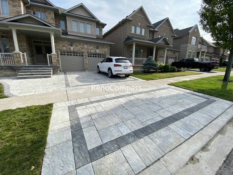This Aurora front and backyard interlocking project features a modern driveway design using large-format concrete pavers with a contrasting border layout. The clean geometric pattern enhances curb appeal while ensuring long-term durability and proper drainage. The interlock driveway seamlessly connects the front entrance and backyard space, creating a cohesive and functional outdoor layout. Designed for both aesthetics and daily use, this project reflects professional craftsmanship and attention to detail, making it an ideal solution for homeowners seeking a modern outdoor upgrade in Aurora.