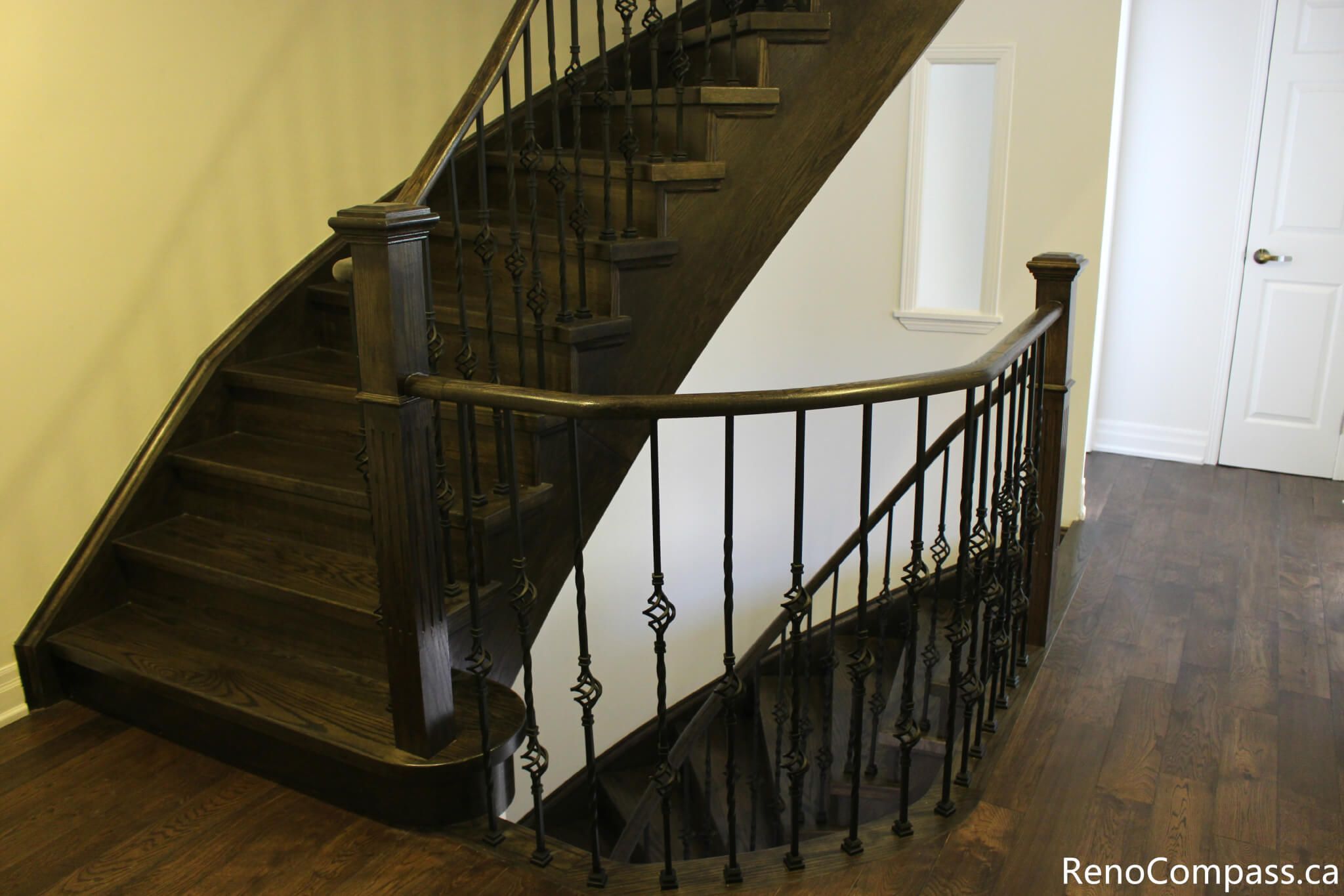 This Mississauga interior renovation features a modern staircase upgrade with dark hardwood steps, custom iron railings, and a bright open entryway design. The clean wall finishes, recessed lighting, and updated flooring enhance both functionality and visual appeal, creating a welcoming and elegant interior space. Completed by a trusted Toronto renovation company, Reno Compass Inc., this project highlights professional craftsmanship and contemporary home renovation design.
