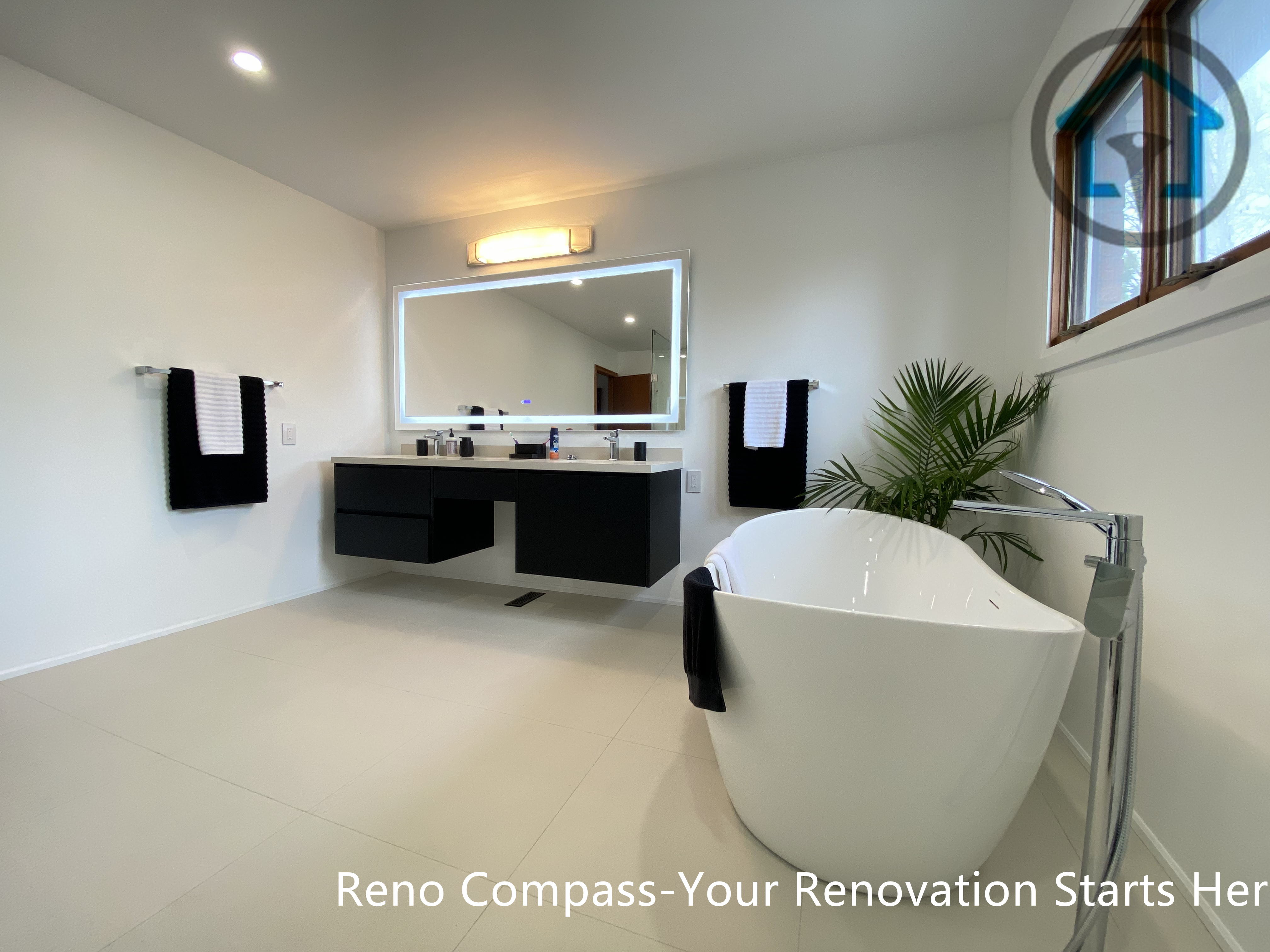 Luxury bathroom renovation in Brampton featuring a freestanding soaking tub paired with a floating double vanity and backlit LED mirror. The open layout, neutral-tone flooring, and minimalist finishes create a calm, spa-inspired environment. Completed by a professional Toronto renovation company, this bathroom design combines modern aesthetics, functionality, and everyday comfort.