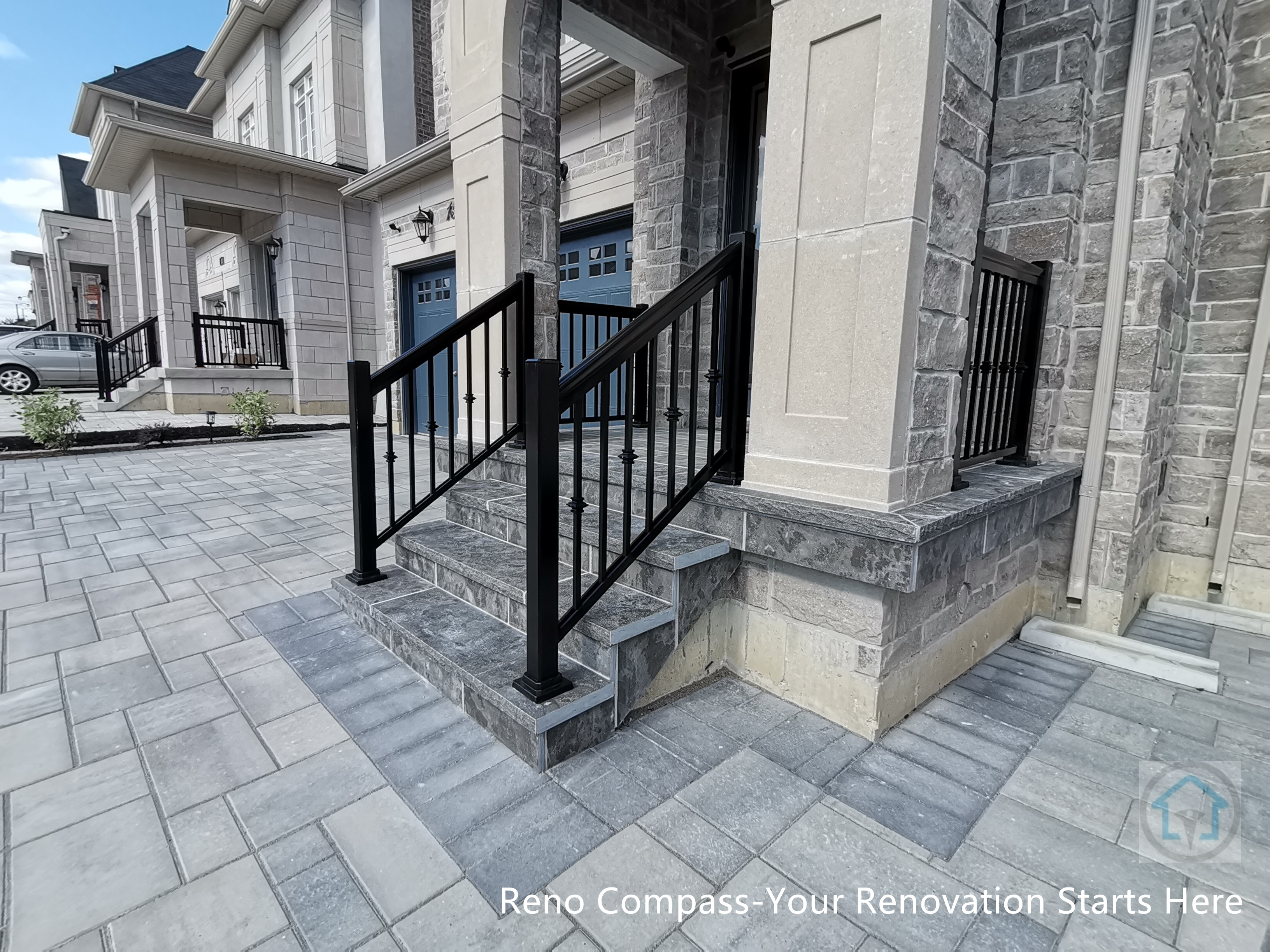 This Vaughan front entrance renovation highlights custom stone steps and a structured walkway leading to the main door. The natural stone finish, clean joint lines, and black metal railings create a refined and durable entry experience that seamlessly connects the driveway with the home’s front façade.