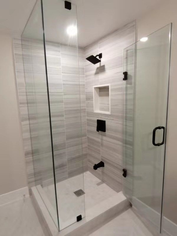 This Richmond Hill interior partial renovation features a modern bathroom upgrade with a frameless glass shower enclosure, custom tile walls, and a built-in shower niche for added functionality. Matte black fixtures and clean tile finishes create a sleek, contemporary design while improving everyday usability and comfort. The renovation focuses on enhancing both style and practicality with high-quality materials and professional craftsmanship. Completed by Reno Compass, this bathroom remodeling project highlights modern interior renovation services for homes across Richmond Hill and the Greater Toronto Area.