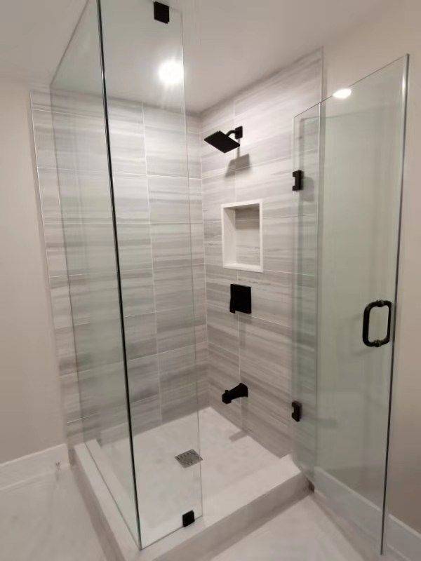 This Richmond Hill interior partial renovation features a modern bathroom upgrade with a frameless glass shower enclosure, custom tile walls, and a built-in shower niche for added functionality. Matte black fixtures and clean tile finishes create a sleek, contemporary design while improving everyday usability and comfort. The renovation focuses on enhancing both style and practicality with high-quality materials and professional craftsmanship. Completed by Reno Compass, this bathroom remodeling project highlights modern interior renovation services for homes across Richmond Hill and the Greater Toronto Area.