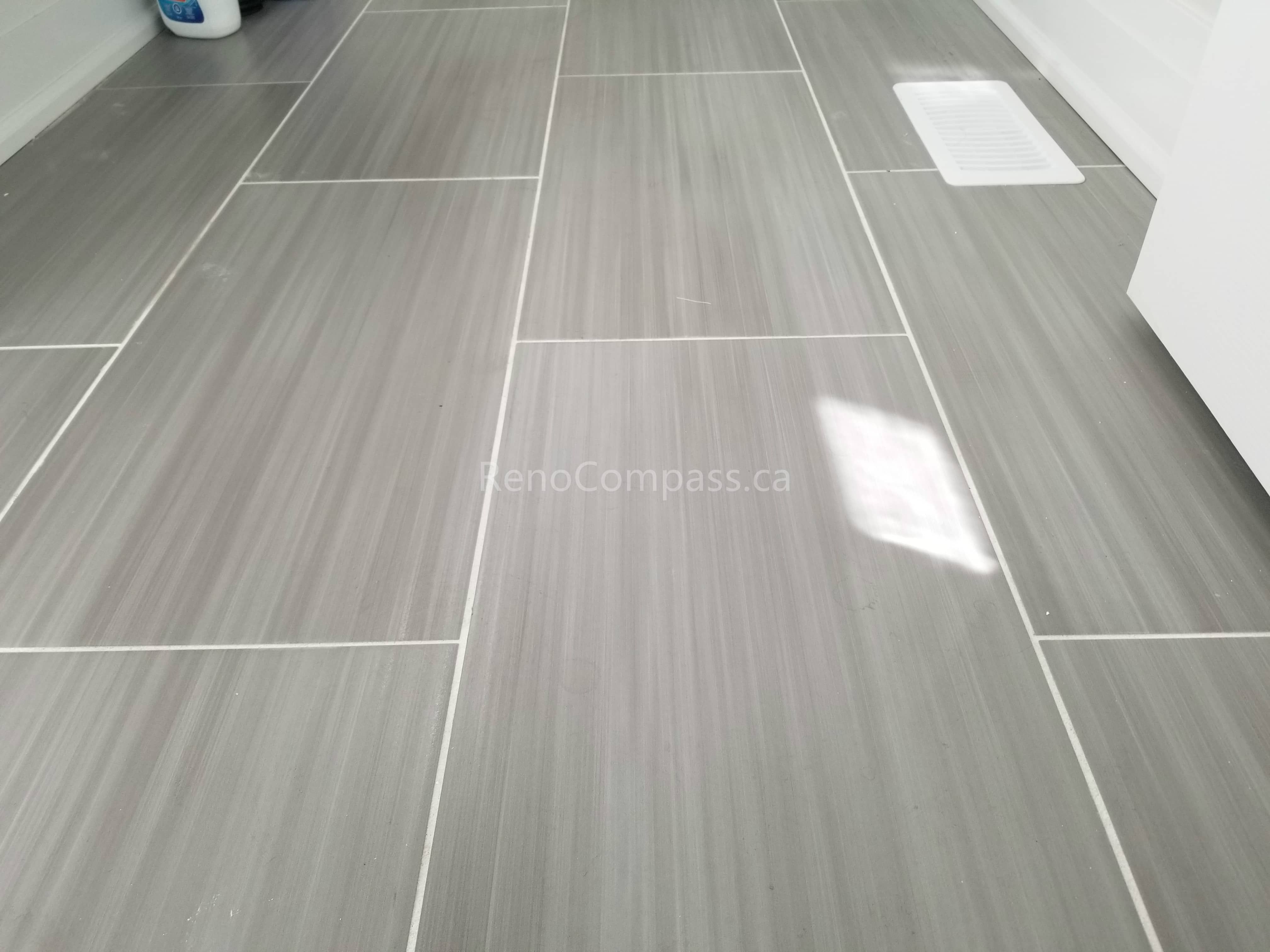 This Toronto interior renovation features high-quality gray porcelain tile flooring with a clean linear pattern and precise grout lines. The durable, low-maintenance tile enhances the space with a modern and elegant finish, ideal for kitchens, bathrooms, or laundry areas. Completed by a professional Toronto renovation contractor, this flooring installation showcases Reno Compass Inc.’s craftsmanship and attention to detail in high-end interior renovations.
