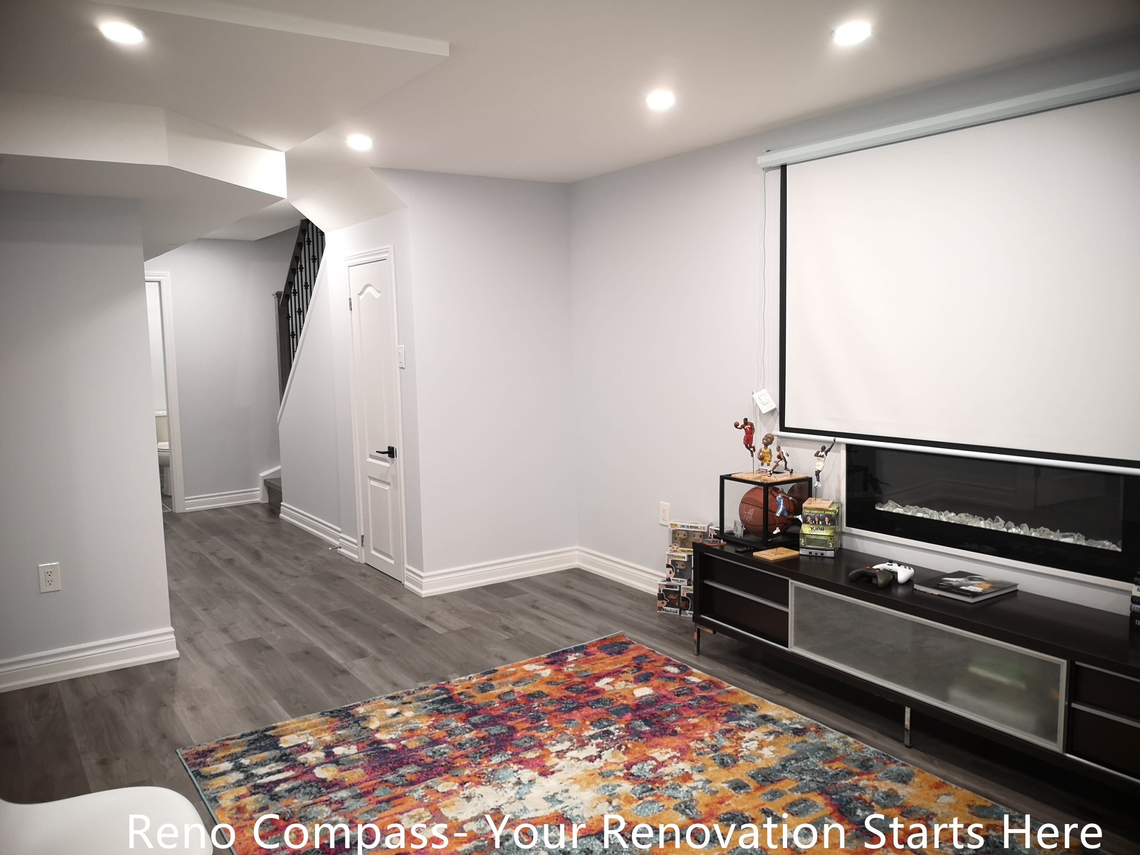 This Whitby basement renovation showcases a finished basement designed with neutral tones to maximize light reflection and spatial comfort. The cohesive flooring and streamlined wall finishes create a calm, balanced environment suitable for entertainment, home office use, or additional living space. The overall design emphasizes practicality, durability, and modern aesthetics.
