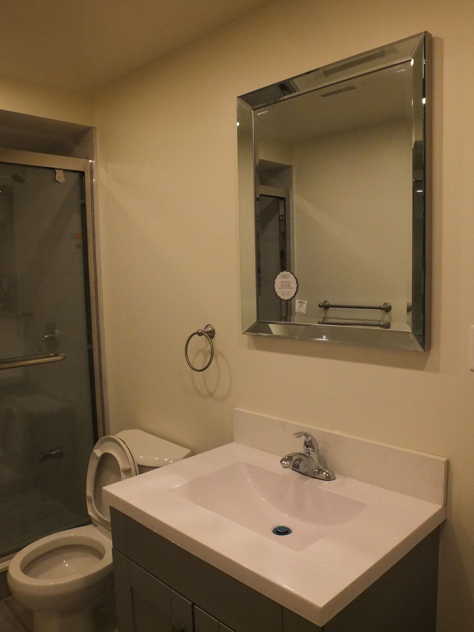 This Vaughan basement bathroom renovation highlights a clean and modern vanity installation paired with a sleek framed mirror and glass shower enclosure. Completed by a professional Toronto Renovation Company, the space features durable flooring, efficient layout planning, and neutral finishes that enhance brightness and functionality. The upgraded sink, storage vanity, and well-positioned lighting create a comfortable and practical bathroom environment, ideal for daily use or guest convenience while adding long-term value to the finished basement space.