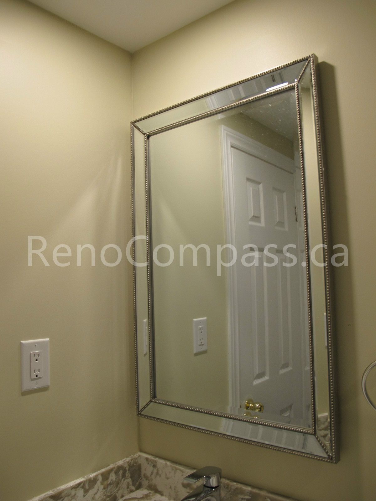Elegant bathroom mirror and vanity detail from a Markham basement renovation project. Featuring a decorative framed mirror, upgraded lighting reflection, and modern countertop finish, this space was completed by Reno Compass to deliver a clean, functional, and stylish basement bathroom design.