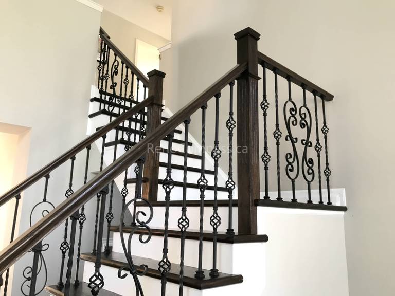 This Markham home renovation features a beautifully upgraded hardwood staircase with dark wood stair treads and elegant wrought iron railings. The contrast between the rich flooring and bright risers creates a clean, modern, and sophisticated visual impact. Completed by a trusted Toronto renovation company, this staircase upgrade enhances both safety and interior aesthetics while maintaining a cohesive flooring design throughout the home.