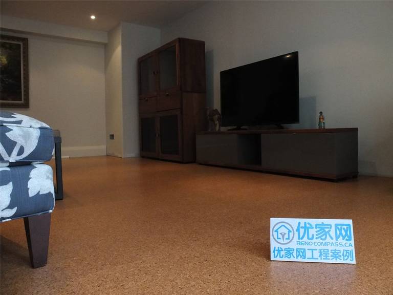 This Oakville basement renovation showcases a clean and comfortable living area featuring warm cork flooring, minimalist wall finishes, recessed pot lights, and modern furniture layout. The renovation focuses on improving basement functionality and creating a cozy entertainment space suitable for family use. As a professional Toronto Renovation Company, Reno Compass Inc. delivered high-quality craftsmanship and thoughtful design to transform the basement into a stylish and practical living environment.