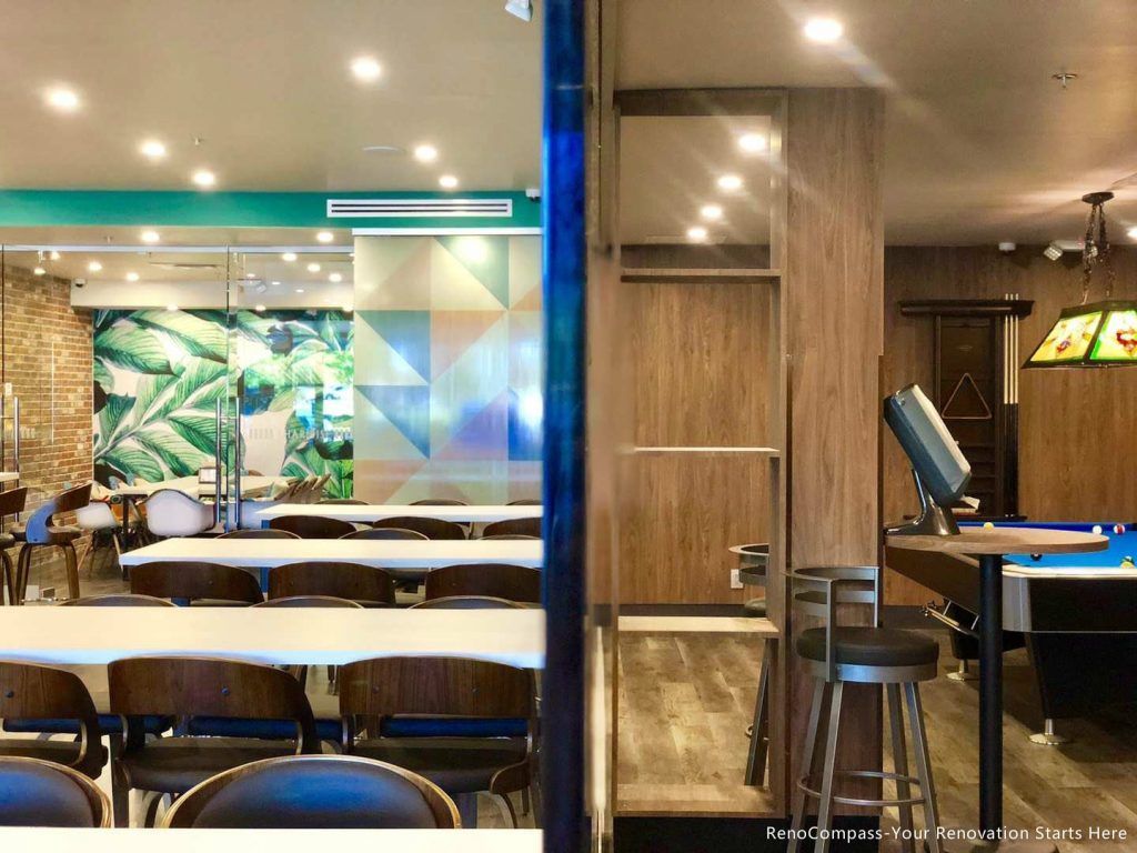 This Barrie commercial renovation highlights a modern bubble tea shop layout featuring open seating areas, custom finishes, and integrated entertainment space. The combination of dining tables, feature walls, and durable commercial flooring creates a welcoming and functional environment for customers. Completed by Reno Compass Inc., a trusted Toronto renovation company, this project showcases professional commercial construction for cafés, dessert shops, and retail spaces across Barrie and surrounding areas.