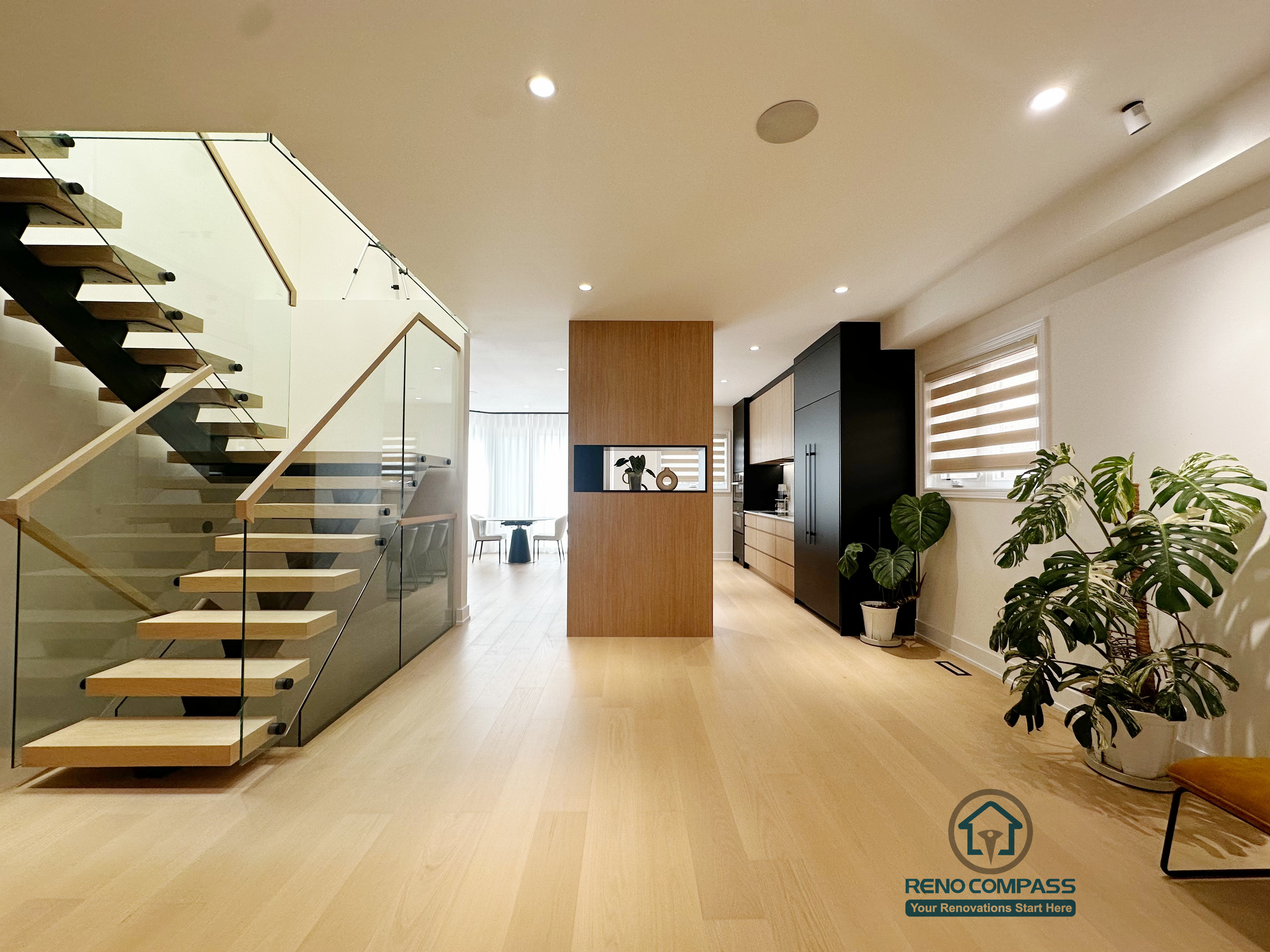 This Markham home renovation features a custom floating steel staircase designed to enhance openness and visual flow. The steel structure is paired with solid wood treads and a tempered glass railing, ensuring safety while maintaining a light, modern appearance. Integrated custom storage along the stair and adjacent areas improves space efficiency, allowing functionality and aesthetics to blend seamlessly within the open-concept layout.
