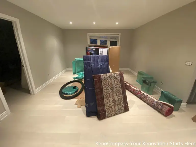 This completed interior renovation features light wood flooring, smooth neutral wall finishes, and evenly spaced recessed ceiling lights that enhance the overall brightness of the space. The open layout allows flexibility for furniture arrangement while maintaining clean sightlines and balanced proportions. Designed and completed by Reno Compass, this renovation focuses on long-term functionality, comfort, and a timeless interior foundation suitable for everyday living.