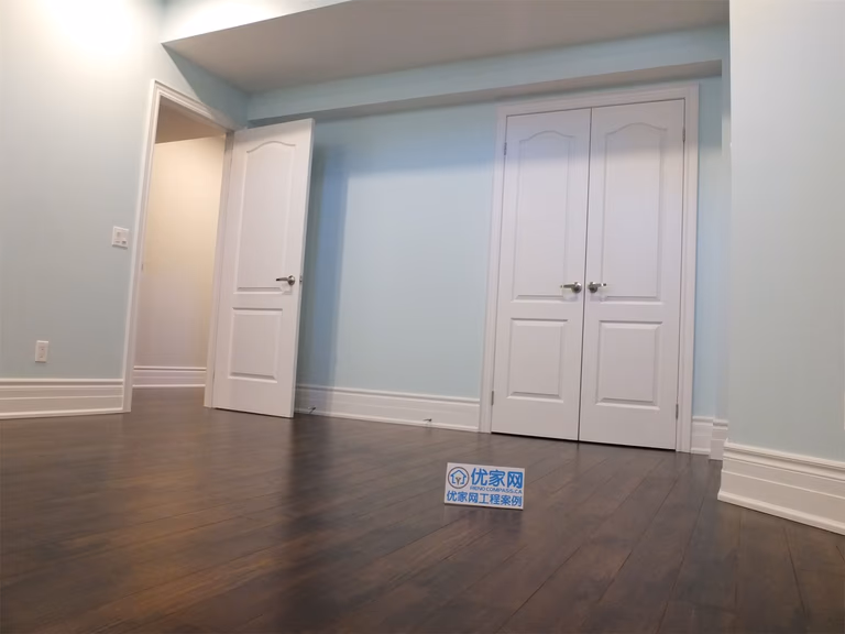 This Richmond Hill basement renovation features a finished bedroom with built-in closet storage, smooth wall finishes, and dark hardwood flooring. The space is designed for comfort and functionality, making it ideal for a guest room, home office, or rental basement unit.