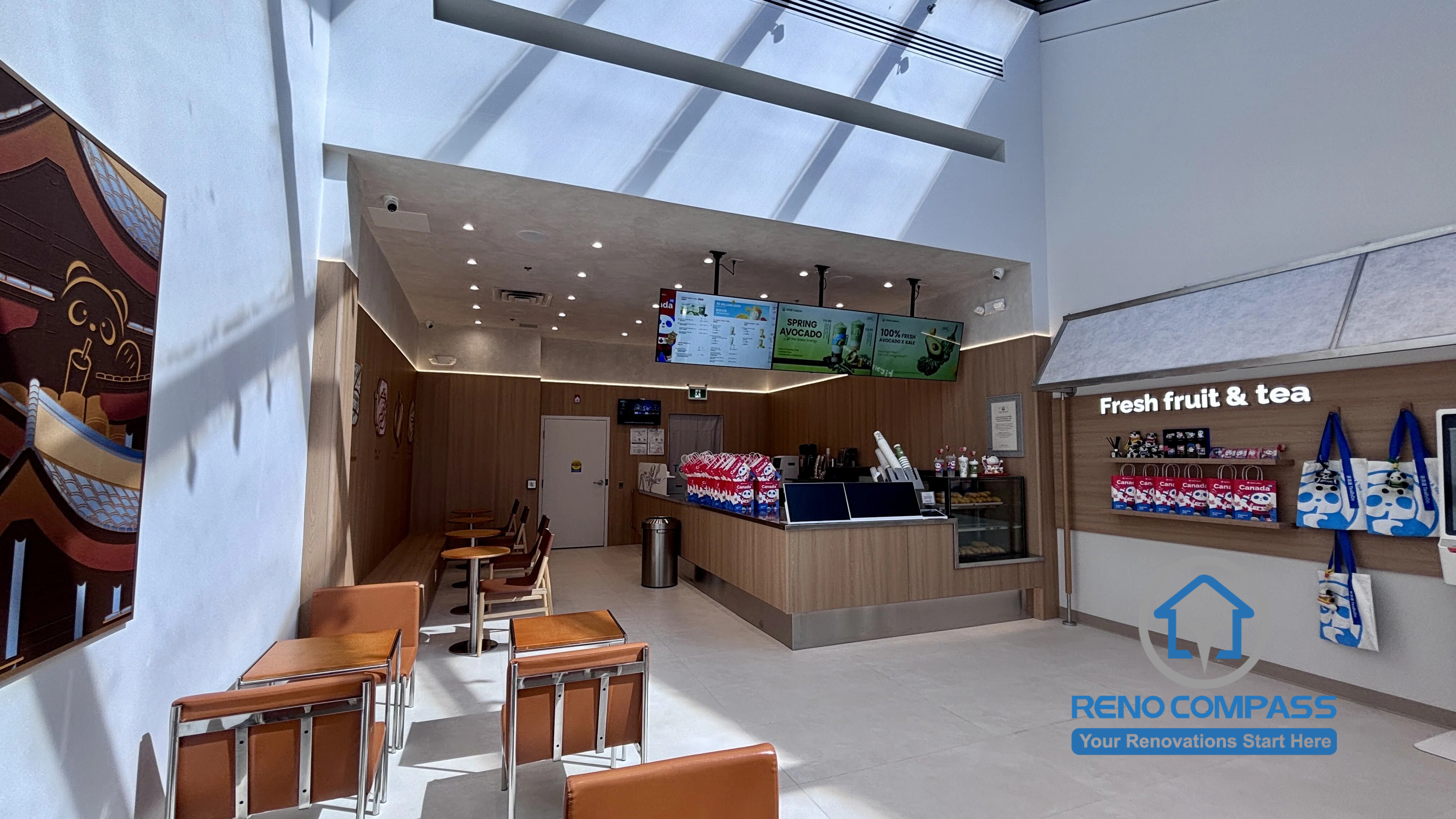 Completed TEABYDO bubble tea shop renovation in Richmond Hill featuring an open-concept café interior with skylight ceiling, modern customer seating area, custom beverage counter, retail display shelving, and clean minimalist commercial design. This bright and welcoming commercial renovation project was completed by Reno Compass serving Richmond Hill, Toronto, and the GTA.