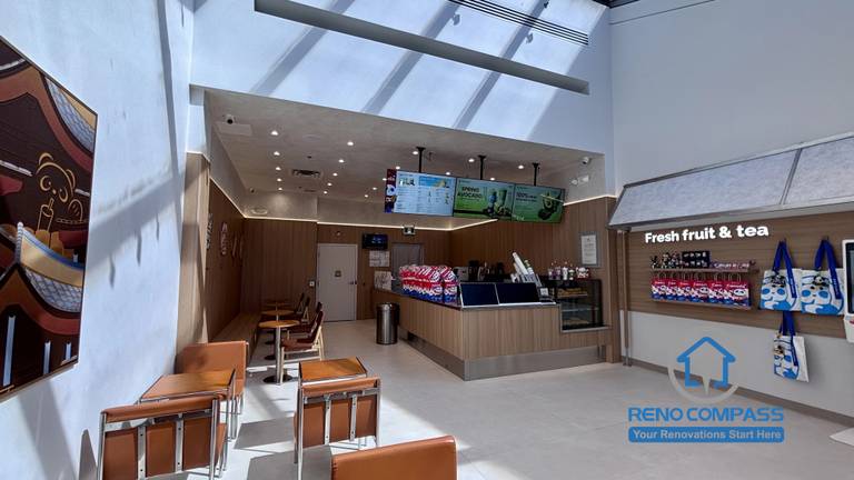 Completed TEABYDO bubble tea shop renovation in Richmond Hill featuring an open-concept café interior with skylight ceiling, modern customer seating area, custom beverage counter, retail display shelving, and clean minimalist commercial design. This bright and welcoming commercial renovation project was completed by Reno Compass serving Richmond Hill, Toronto, and the GTA.