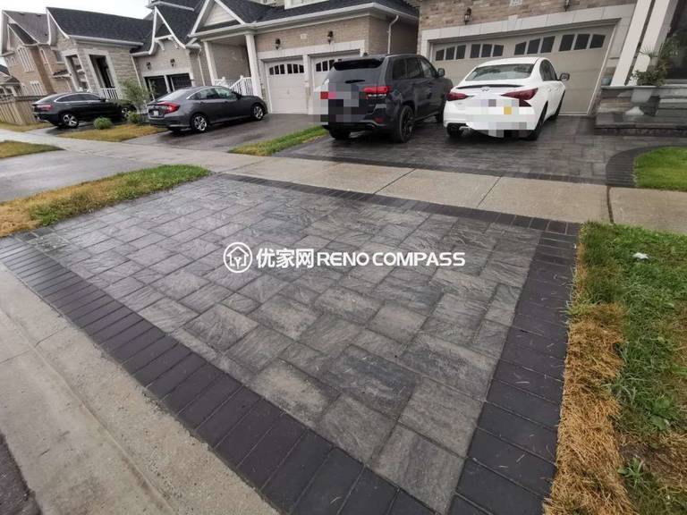 Detailed view of a custom interlocking driveway in Aurora featuring precision‑cut stones and a sleek dark perimeter border. Reno Compass delivered a flawless installation that enhances curb appeal and showcases expert craftsmanship from a trusted Toronto Renovation Company.