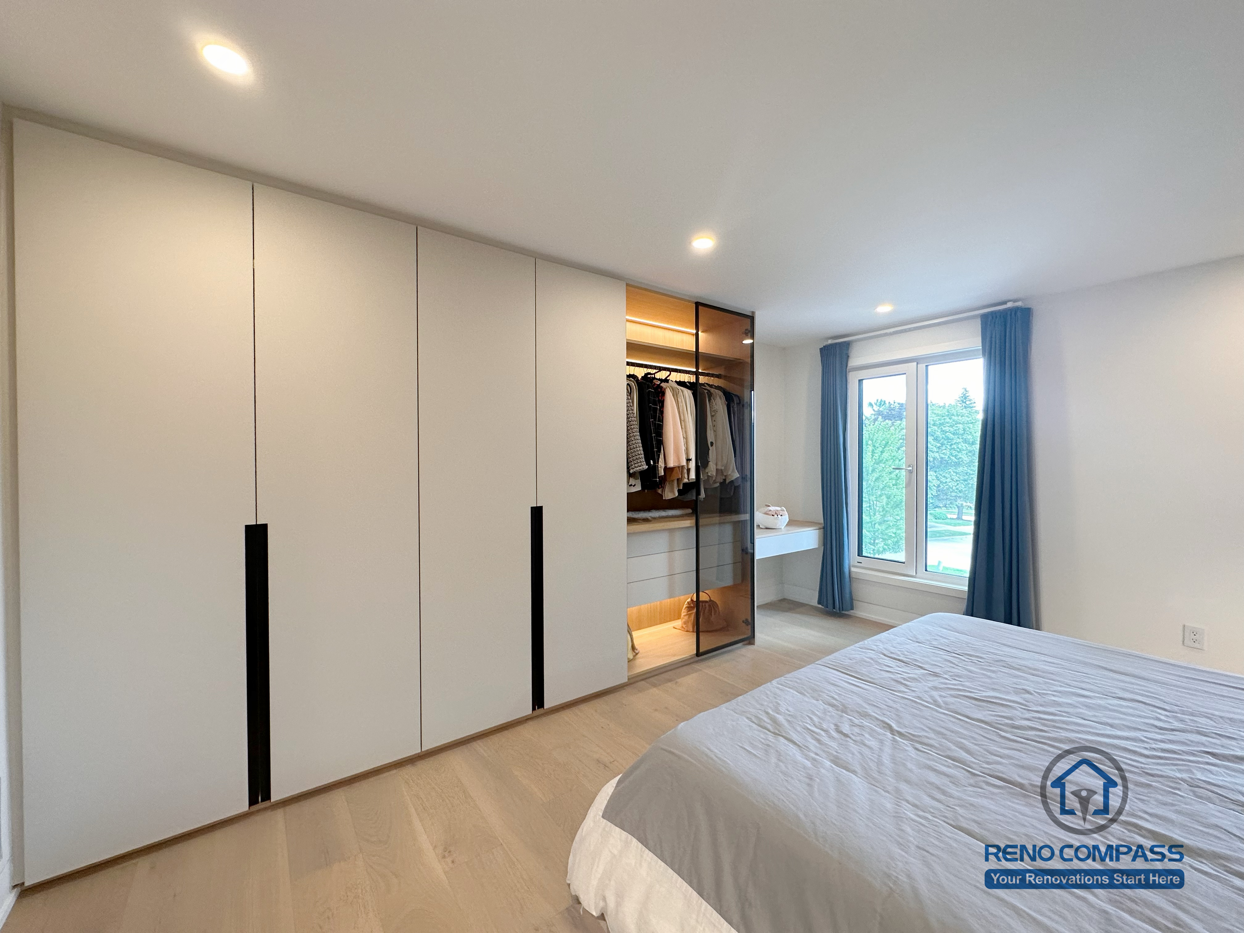 A custom bedroom renovation in Toronto featuring full-height built-in wardrobe cabinetry with integrated hanging storage and concealed drawers. This tailored closet solution maximizes storage efficiency while maintaining a clean, modern bedroom aesthetic, completed by a professional Toronto renovation company.