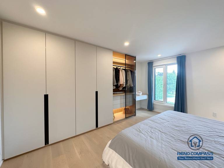 A custom bedroom renovation in Toronto featuring full-height built-in wardrobe cabinetry with integrated hanging storage and concealed drawers. This tailored closet solution maximizes storage efficiency while maintaining a clean, modern bedroom aesthetic, completed by a professional Toronto renovation company.