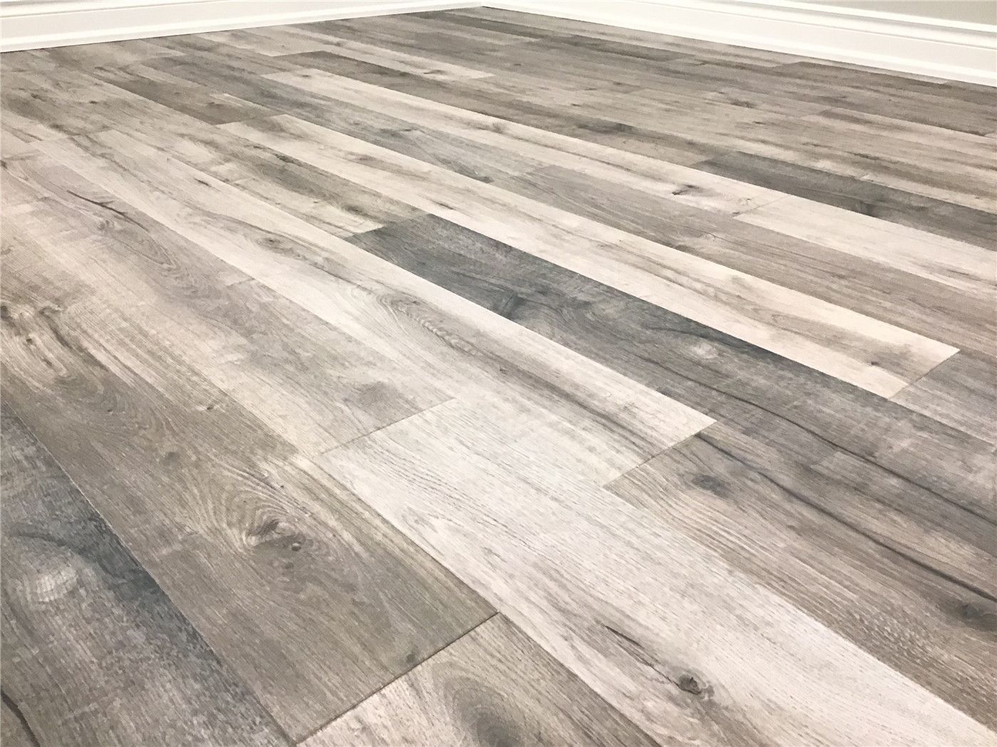 Close-up view of premium grey wood-look vinyl plank flooring installed during this Newmarket basement renovation. The durable, moisture-resistant finish enhances the modern aesthetic while providing long-lasting performance for basement living spaces.