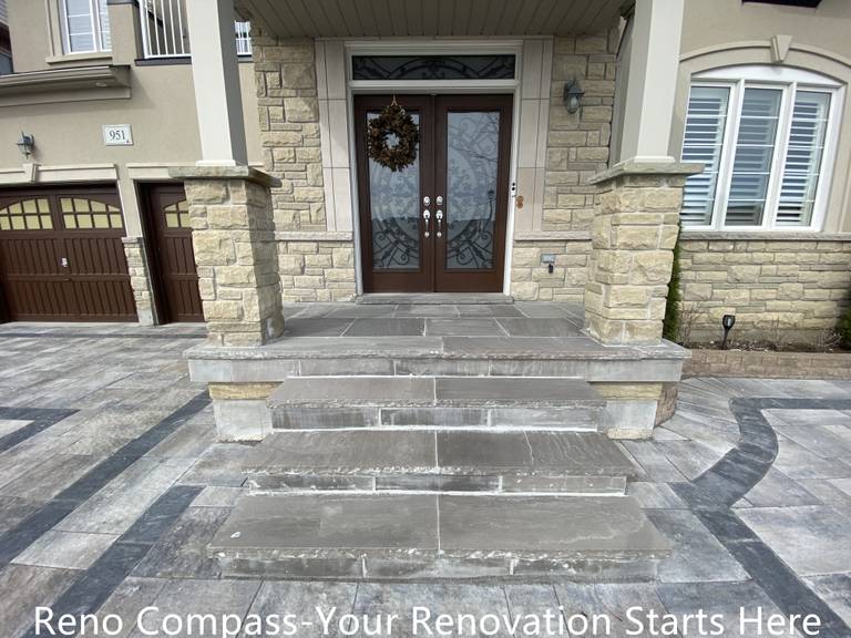 Front entrance interlocking steps renovation in Newmarket featuring large-format stone slabs, clean step alignment, and curved border detailing. The upgraded entryway enhances safety, durability, and visual impact while creating a welcoming transition from driveway to home entrance. Completed by a trusted Toronto renovation company specializing in high-quality exterior renovations.