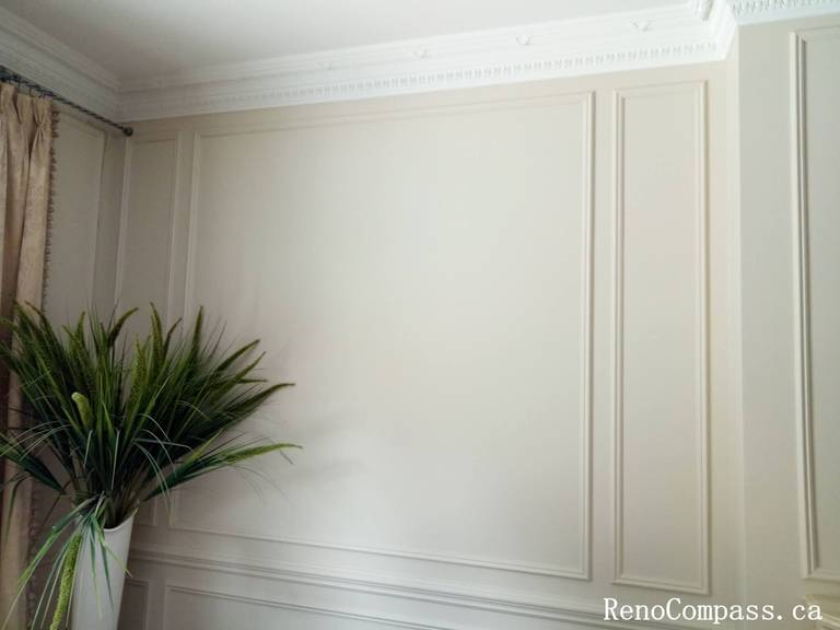 This image showcases a refined interior painting project in North York, featuring custom wall panel molding, elegant crown molding, and a soft neutral color palette. The freshly painted decorative wall panels create depth and symmetry, enhancing the overall brightness and sophistication of the space. Precise surface preparation and clean finishing ensure smooth lines and a high-end result, ideal for modern and classic home interiors. This North York painting project highlights professional craftsmanship and attention to architectural details, delivering a timeless and polished interior look.