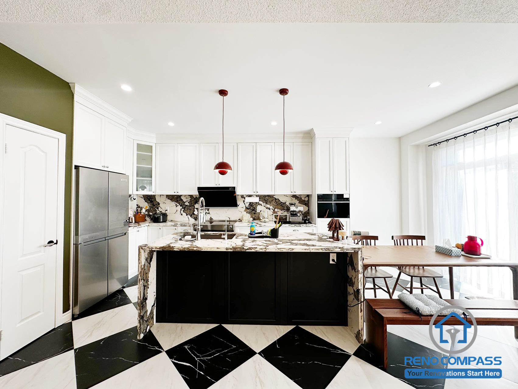This modern kitchen renovation in Markham features a full-height custom cabinetry layout, a bold marble waterfall island, and a black-and-white contrast floor design. The open-concept layout improves circulation between the kitchen and dining area, combining visual impact with everyday functionality.