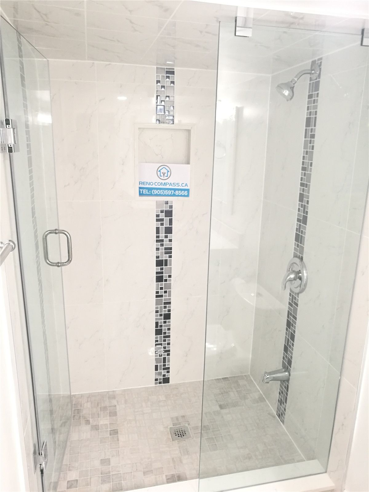 Bathroom renovation project in Pickering featuring a modern white vanity with quartz countertop, undermount sink, large mirror, and a frameless glass shower enclosure. The neutral tile flooring and clean layout enhance brightness and functionality, completed by a professional Toronto renovation company.