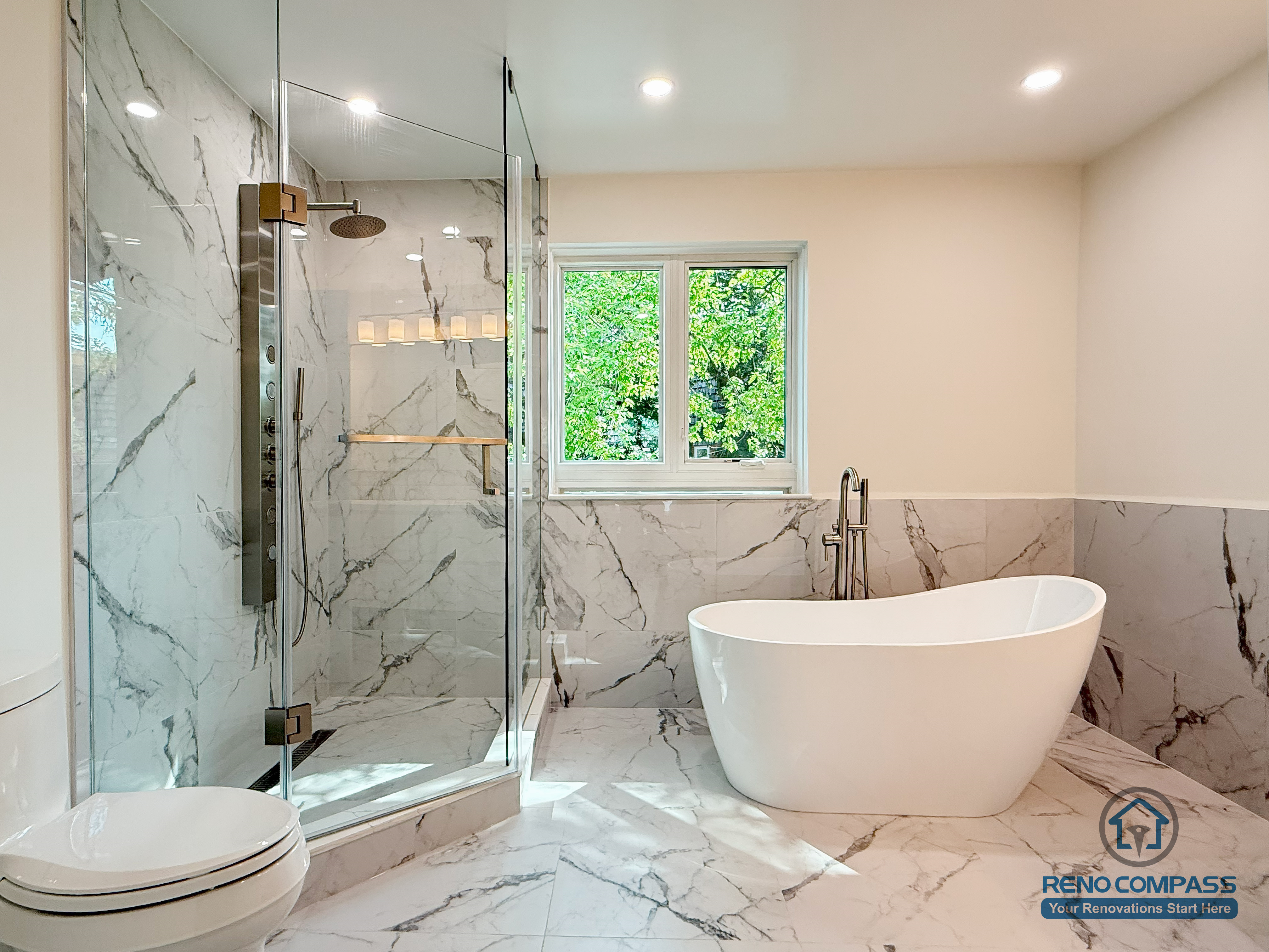 A serene and modern bathroom renovation in North York featuring a sculptural freestanding tub, a spacious glass-enclosed shower, and marble-style tiles throughout. The warm natural light from the upgraded window enhances the clean, spa-like atmosphere, creating a relaxing space for everyday comfort.
清新又现代的北约克浴室翻新，采用独立式浴缸、大面积玻璃淋浴间与整屋大理石纹瓷砖。自然采光充足，整体呈现酒店级的静奢氛围，是日常放松的理想空间。