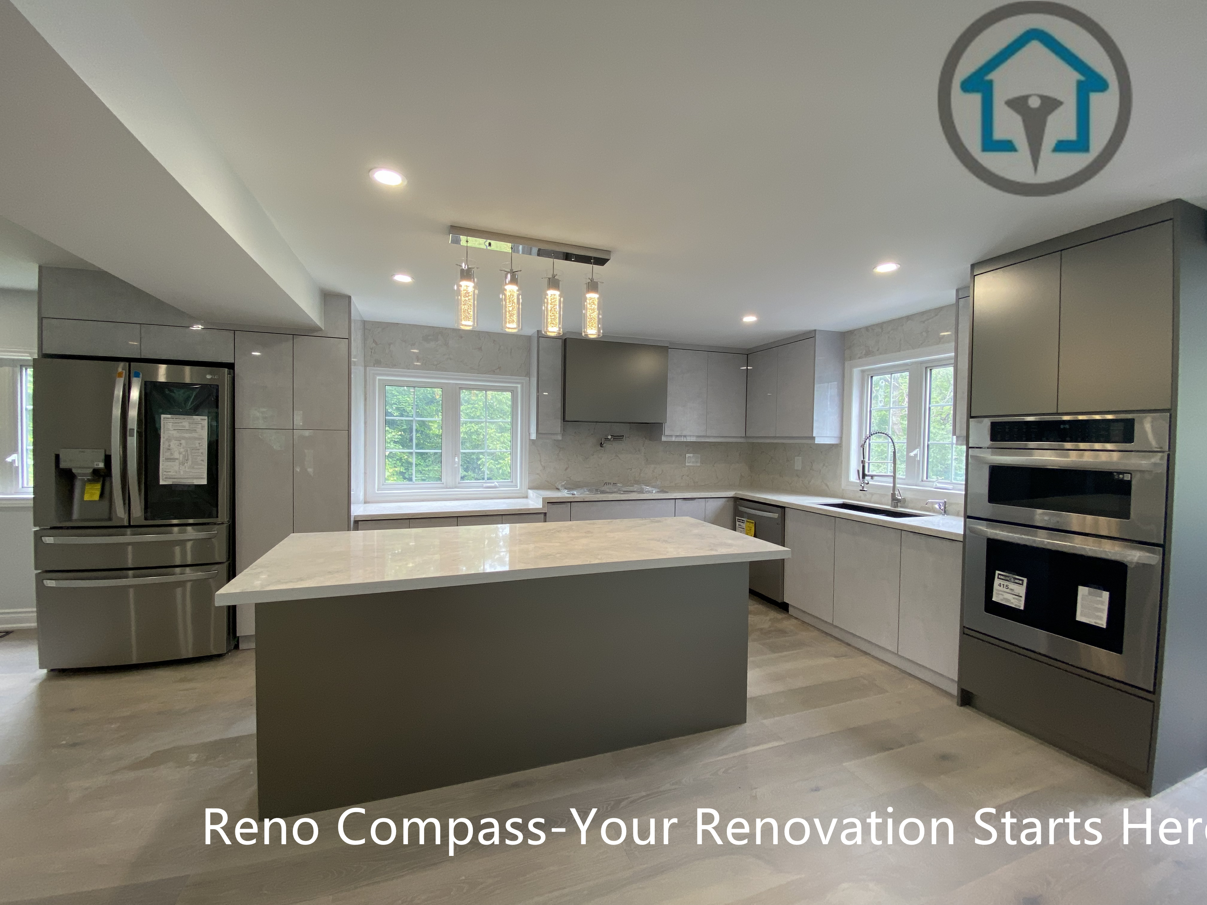 This Stouffville kitchen renovation features a spacious open-concept layout with a large waterfall island, custom grey cabinetry, integrated stainless steel appliances, and layered recessed lighting. The design emphasizes clean lines, efficient workflow, and natural light, creating a highly functional and contemporary family kitchen.