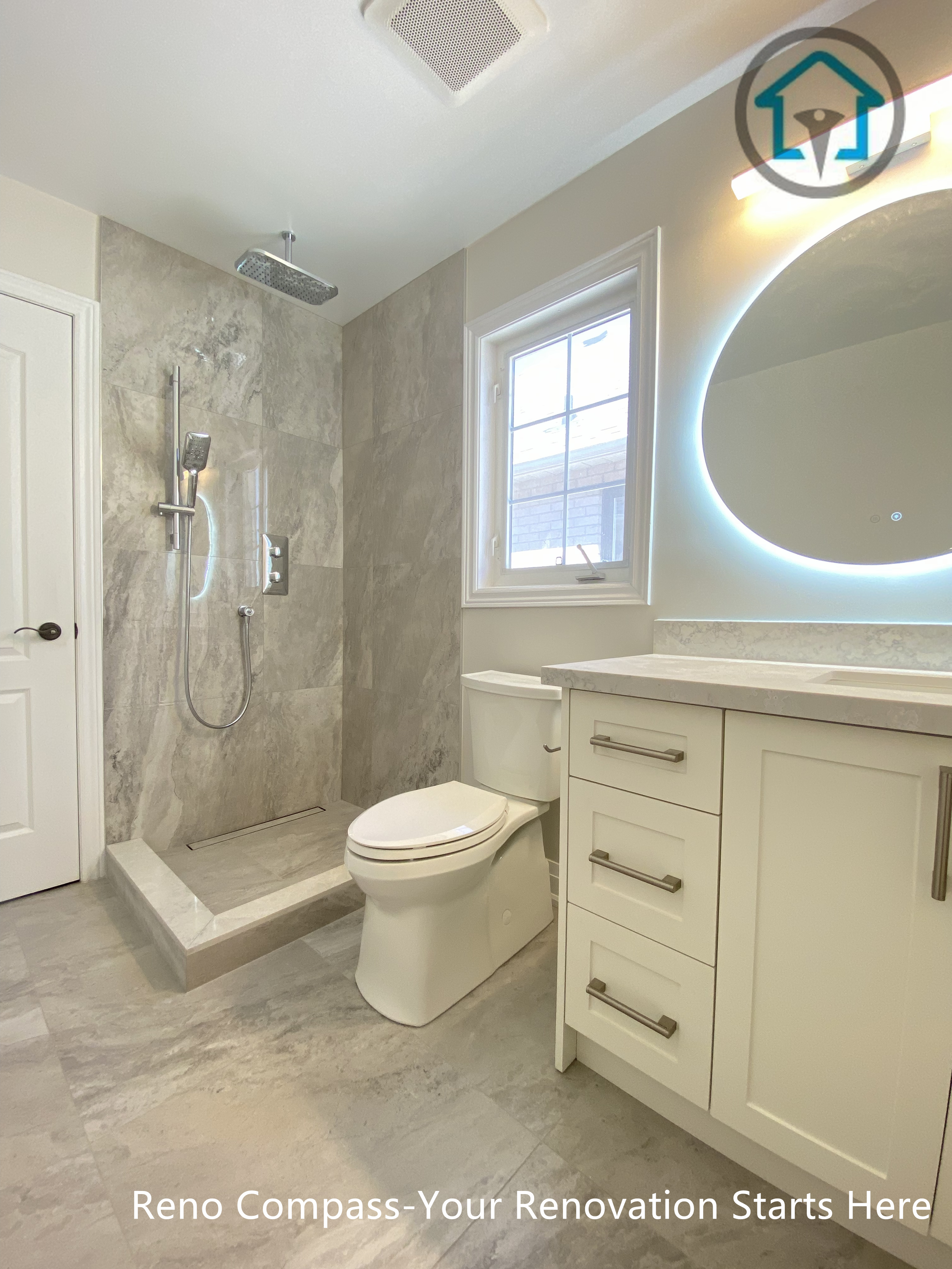 This Richmond Hill bathroom renovation features a walk-in shower with neutral tile finishes, a modern vanity with integrated lighting, and a clean, functional layout. The design emphasizes practicality, brightness, and long-term usability, completed by an experienced Toronto renovation company.